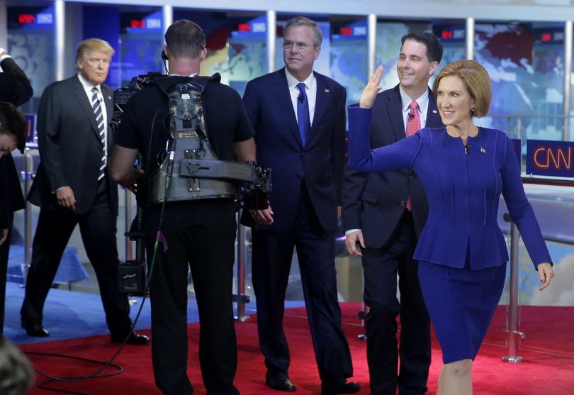 Republican presidential candidate, businesswoman Carly Fiorina, right, leads fellow candidates Scott Walker, second from right, Jeb Bush, center, and Donald Trump as they take the stage prior to the CNN Republican presidential debate at the Ronald Reagan Presidential Library and Museum on Wednesday in Simi Valley, Calif. (AP Photo/Chris Carlson)