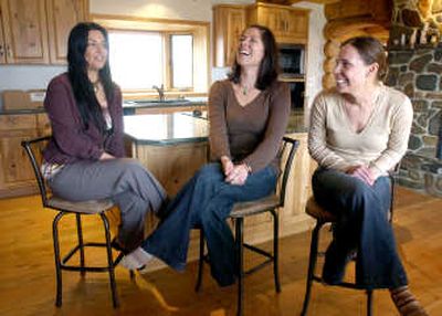 
From left, Genevieve King, Jody Perez and Heather Cahoon sit in the kitchen Wednesday  where 