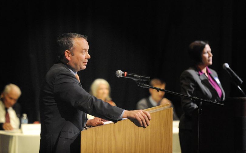 Spokane Mayor David Condon, left, and his opponent, Shar Lichty, right, at the candidate debates held by the Chase Youth Commission Wednesday, Oct. 7, 2015 at North Central High School. (Jesse Tinsley / The Spokesman-Review)