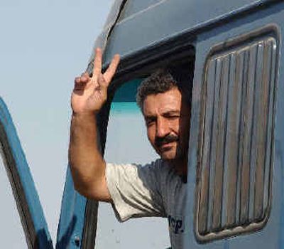 
Mohammed Khleifat, 41, one of four Jordanian former hostages, waves from a truck after he was freed. 
 (Associated Press / The Spokesman-Review)