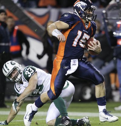 Denver Broncos quarterback Tim Tebow gets by New York Jets free safety Eric Smith on his way to a winning touchdown in the fourth quarter Thursday night. (Associated Press)