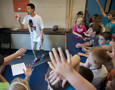 Daniel Robinson exhibits his kendama skills to children at the Boys and Girls Club on Aug. 9, in Mead. (Dan Pelle)
