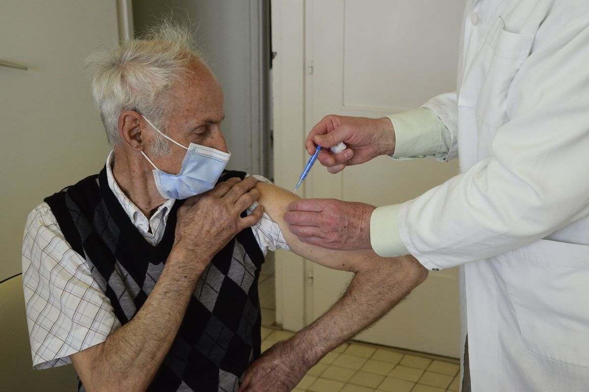 General practitioner Gyorgy Teleki vaccinates a patient with the second dose of COVID-19 vaccine produced by Chinese Sinopharm in Taplanszentkereszt, Hungary, Thursday, April 1, 2021, as the national vaccination campaign against the new coronavirus continues in the country.  (Istvan Filep)
