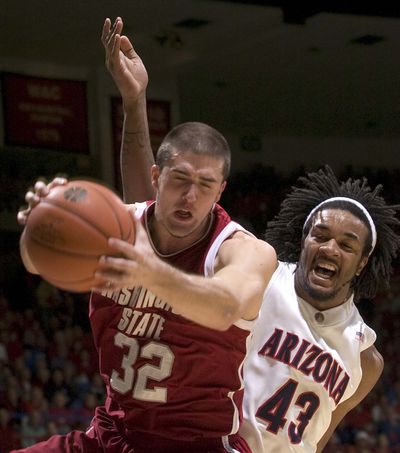 WSU's Daven Harmeling grabs a rebound in front Arizona' Jordan Hill. (John Miller / Associated Press)