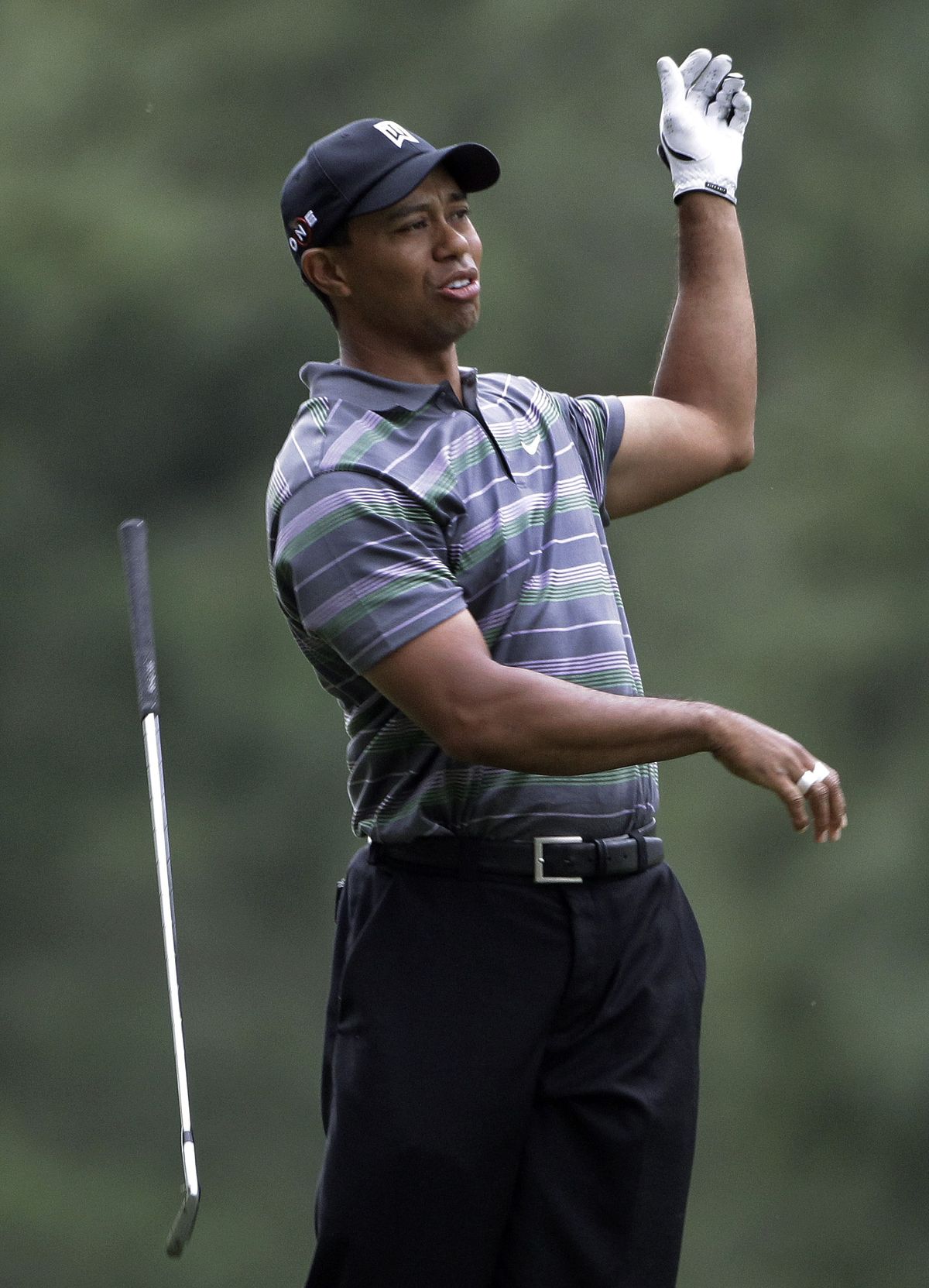 Tiger Woods’ round wasn’t perfect, as shown by his reaction to missing an eagle putt on the 13th hole. (Associated Press)