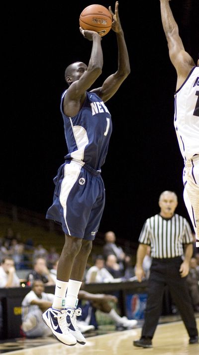 Nevada guard Patrick Nyeko (1) hits a 3-point shot over Idaho guard Mike McChristian, right, during the first half of an NCAA college basketball game, Thursday, Jan. 5, 2012, in Moscow, Idaho. (Associated Press)