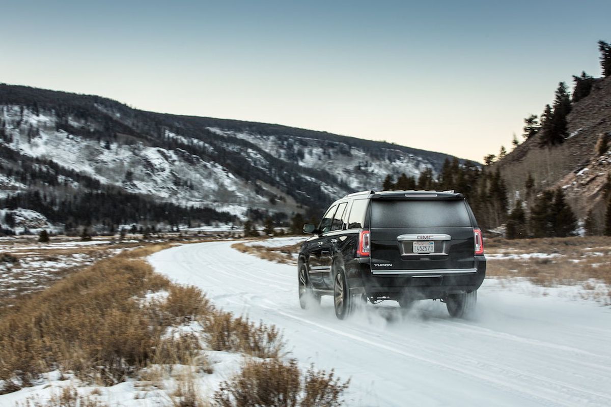 The Yukon is built on a rugged ladder-frame chassis with a solid rear axle. It’s heavy (5379/5610 pounds) and carries its weight up high. (GMC)
