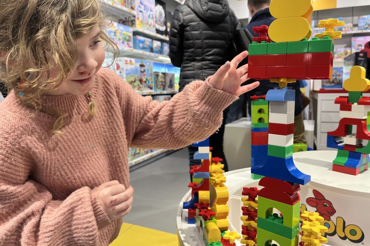 Six-year-old Camilla Thrasher assembles structures of Lego in the downtown Lego store on Tuesday.  (Elena Perry)