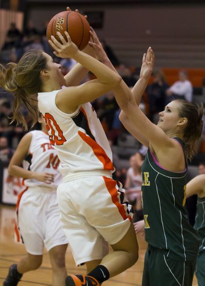 Shadle's Chelsea Chandler, right, fouls Lewis and Clark's Taylor Howlett in the third period. (Colin Mulvany)