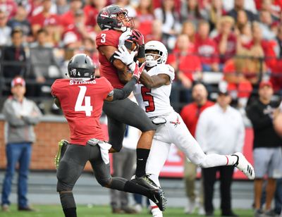 Washington State cornerback Darrien Molton intercepts a pass intended for Eastern Washington wide receiver Nsimba Webster (5) during the first half of a nonconference game on Sept. 15, 2018, in Pullman. The Cougars won the home game 59-24.  (TYLER TJOMSLAND/THE SPOKESMAN-REVIEW)