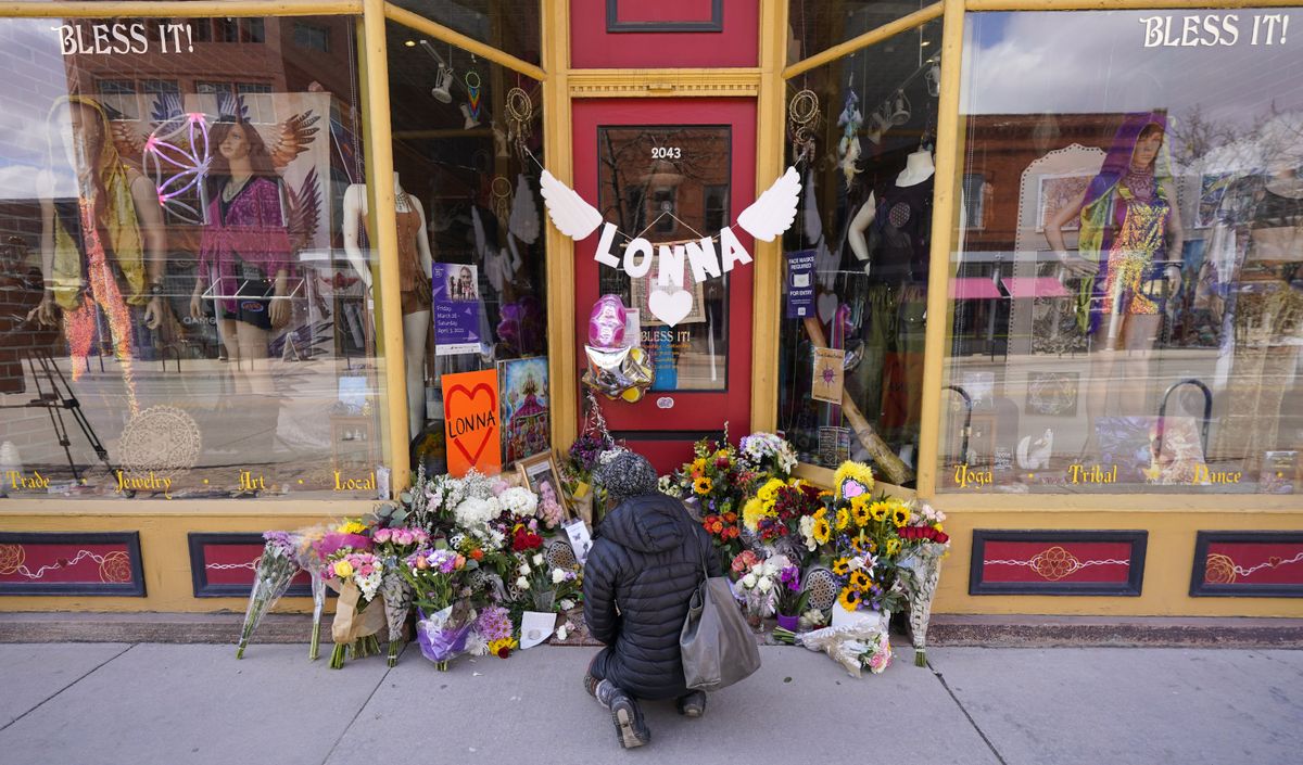 Jacqui Mirell of Boulder, stops to look at a tribute outside the store owned by one of 10 victims in the mass shooting at a Boulder King Soopers grocery store Wednesday, March 24, 2021, in Boulder, Colo. Mirell shopped at the store.  (David Zalubowski)