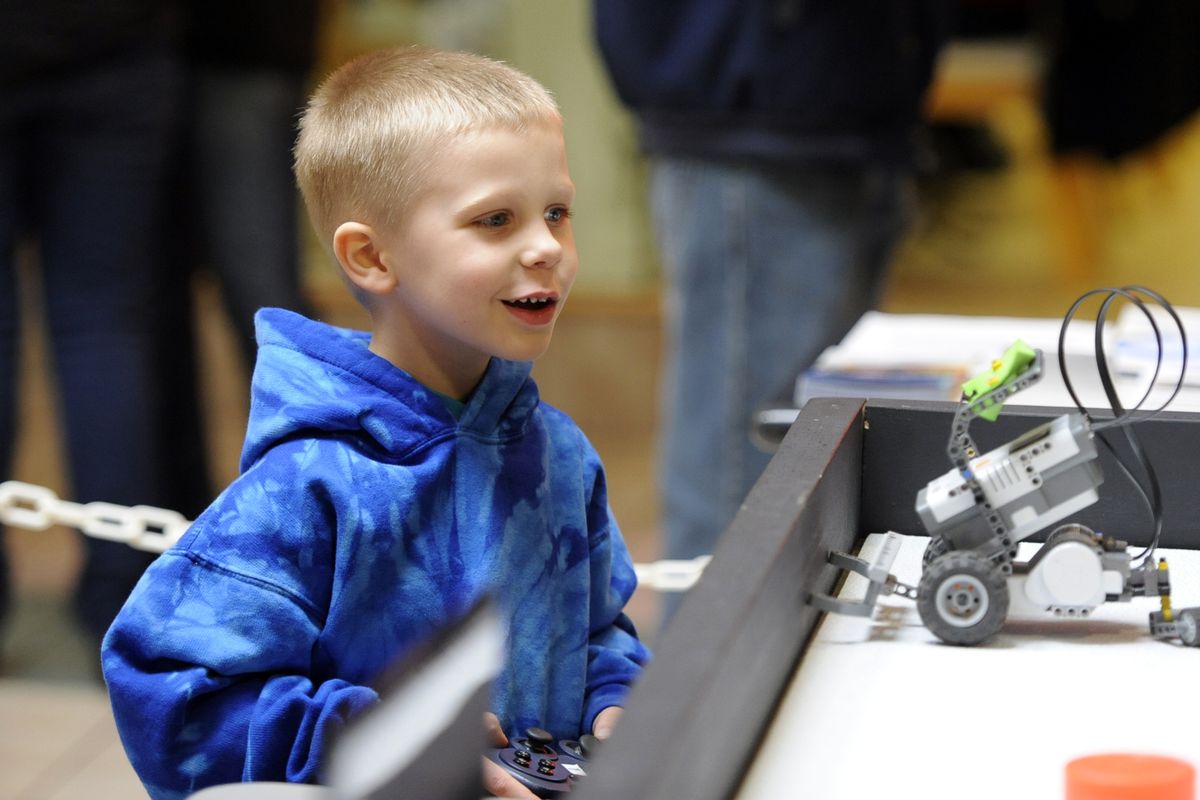 Noah Best, 4, tries to operate a robot vehicle made available by a middle school robotics club Saturday at the Invent Idaho event at Silverlake Mall in Coeur d