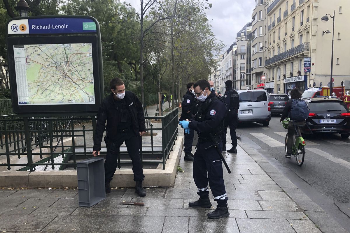 Police officers stand by a knife, seen on the ground, in Paris, Friday, Sept. 25, 2020. French terrorism authorities are investigating a knife attack that wounded at least two people Friday near the former offices of the satirical newspaper Charlie Hebdo in Paris, authorities said. A suspect has been arrested.  (SOUFIAN FEZZANI)