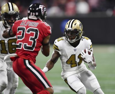 This Dec. 7, 2017, file photo shows New Orleans Saints running back Alvin Kamara (41) running near Atlanta Falcons cornerback Robert Alford (23) during the first half of an NFL football game in Atlanta. Kamara and several other recently injured Saints returned to practice Wednesday, providing New Orleans hope of getting back several offensive and defensive regulars as they try to maintain their slim lead atop the NFC South. (Danny Karnik / Associated Press)