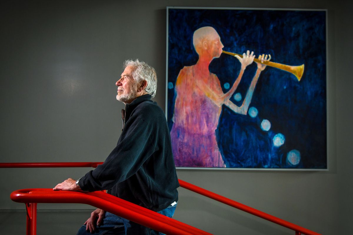 Artist Mel McCuddin with his untitled work displayed in the Spokane Veterans Memorial Arena on Oct. 29, 2018.  (DAN PELLE)