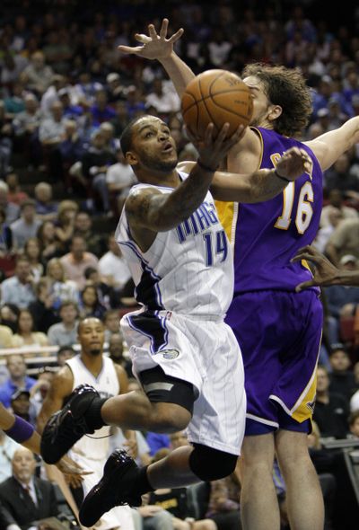 Magic guard Jameer Nelson slips past Lakers forward Pau Gasol.  (Associated Press)