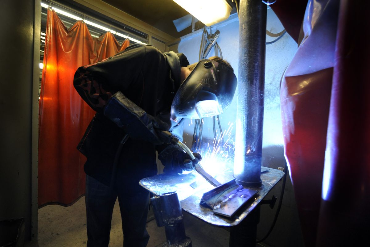 Lakeland High School senior Cody Schwarzkopf works on his welding technique Friday in a booth at the North Idaho College welding program building in Coeur d’Alene. NIC welding students helped the high school students with a welding contest. (PHOTOS BY JESSE TINSLEY)
