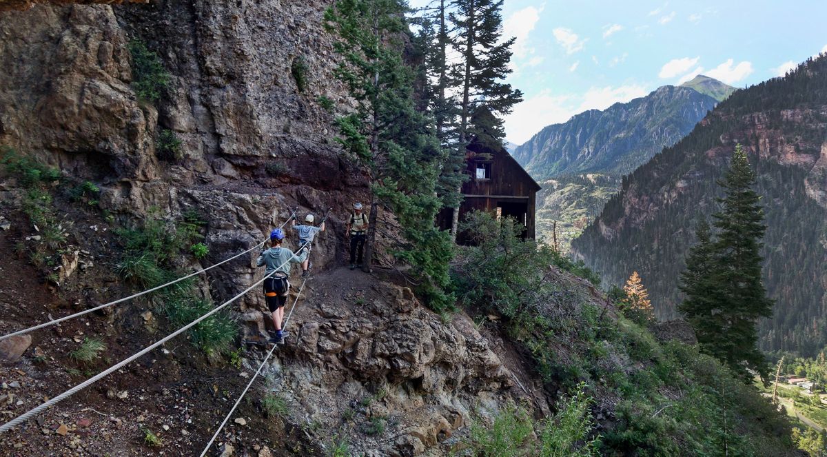 Henry and Silas, the author’s sons, cross the first of two suspended bridges that are part of the Gold Mountain Via Ferrata in Ouray, Colo. (Rachel Walker/For the Washington Post)
