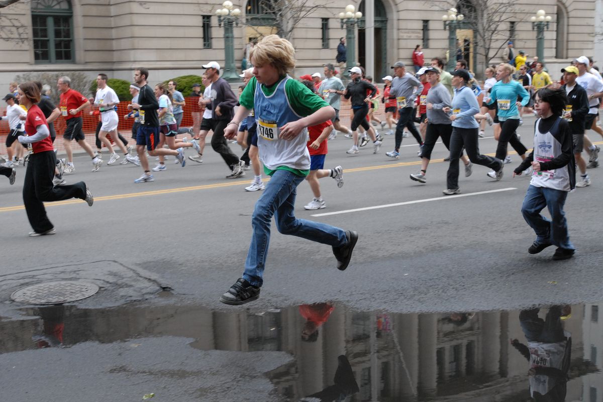 A runner jumps a water puddle on Riverside Avenue shortly after the start of the 2009 Bloomsday Run. (Larry Reisnouer / The Spokesman-Review)