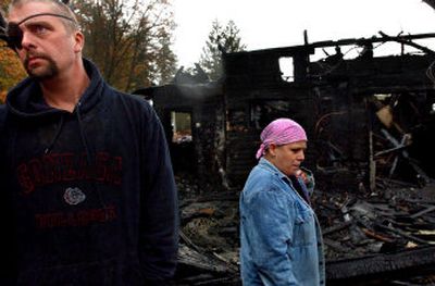 
Dan and Leanda Arlt look over the remains of their burned out rental home in Harrison on Wednesday.  