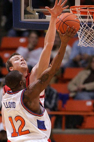 
Eastern Washington center Paul Butorac blocks the shot of Boise State's Kareen Lloyd during the first half of a December contest in Boise.
 (Associated Press / The Spokesman-Review)