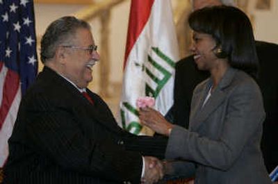 
Iraqi President Jalal Talabani shakes hands with Condoleezza Rice after giving her a flower during their meeting Sunday in Baghdad. Associated Press
 (Associated Press / The Spokesman-Review)