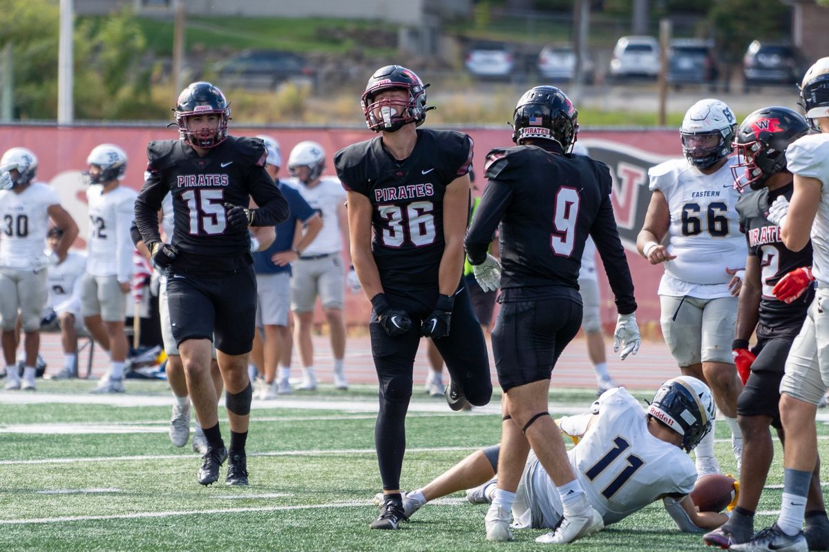 Whitworth defensive back Jacob Brandvold (36) celebrates a stop Saturday with teammates Lucas Reynolds (15) and Ryan Kinney.  (Caleb Flegel/Whitworth Athletics)