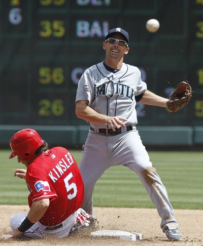 M’s second baseman Jack Wilson commits his second error of the second inning. (Associated Press)