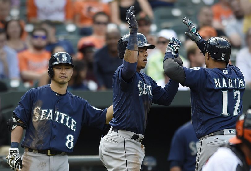 Seattle Mariners, Ketel Marte, center, congratulates Leonys Martin, right, on a two run home run, which Marte score on, against the Baltimore Orioles in the ninth inning of a baseball game, Thursday, May 19, 2016, in Baltimore. Also pictured at left is Norichika Aoki. (Gail Burton / Associated Press)