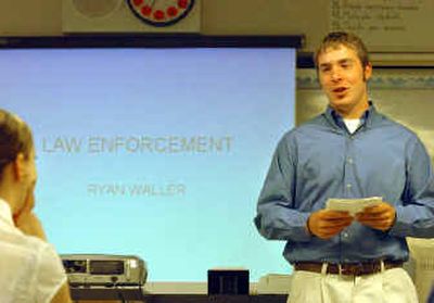 
Ryan Waller, a senior at Coeur d'Alene High, uses PowerPoint and index cards to give a short speech about law enforcement as a career during senior project.  Every senior must research and present a project to judges,  teachers and counselors. 
 (Jesse Tinsley / The Spokesman-Review)