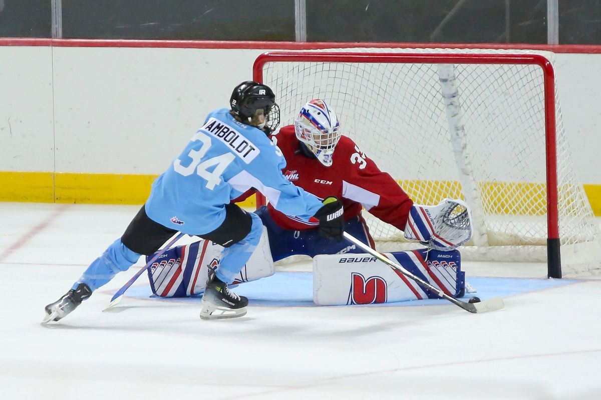 Spokane Chiefs returning goalie Cooper Michaluk makes a save on Tyler Wamboldt in the team