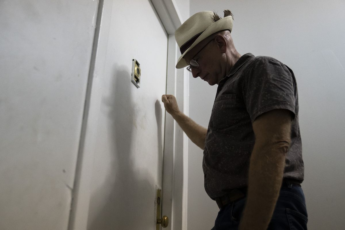 Gary Zaremba knocks on an apartment door as he checks in with tenants to discuss building maintenance at one of his at properties, Thursday, Aug. 12, 2021, in the Queens borough of New York. Landlords say they have suffered financially due to various state, local and federal moratoriums in place since last year. “Without rent, we’re out of business," said Zaremba.  (John Minchillo)