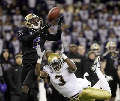 UW’s Desmond Trufant, left, deflects and nearly intercepts a pass intended for Josh Smith.  (Associated Press)
