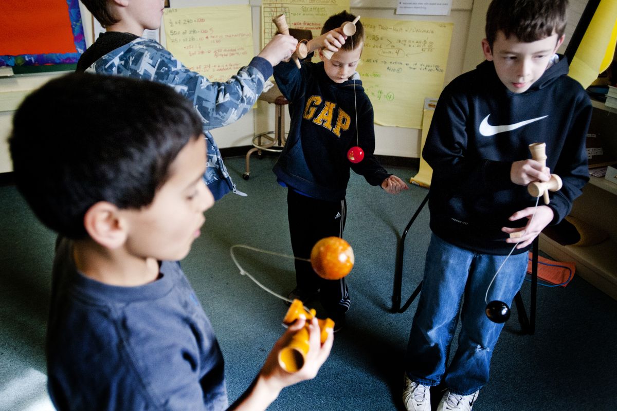 Clockwise from foreground, fifth-grader Kaleb O’Neall and third-graders Mason Boyer-Kendrick and Emmett Anderson practice their kendama tricks with sixth-grader Joel Morris, right, during an after-school kendama club Tuesday at Finch Elementary School in Spokane. (Tyler Tjomsland)