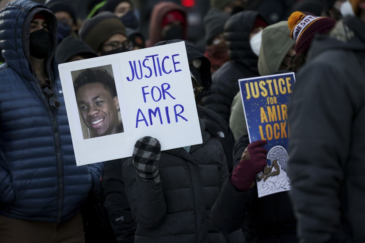 A protester holds a sign demanding justice for Amir Locke at a rally on Saturday, Feb. 5, 2022, in Minneapolis. Hundreds of people filled the streets of downtown Minneapolis after body cam footage released by the Minneapolis Police Department showed an officer shoot and kill Locke during a no-knock warrant. (Christian Monterrosa)