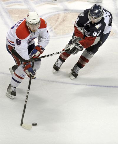 Spokane Chiefs Brenden Kichton (8) and Tri-City Americans David Conrad (32) compete for the puck in the first period of game 6 of their WHL playoff game Tuesday, April 19, 2011 in the Spokane Arena. (Colin Mulvany / The Spokesman-Revew)