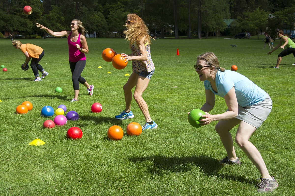 Summer Games participants, from left, Terry Perry, Jessica Kenlein, Linnea Carlson, and Laurie Feola play a game of island ball – similar to dodgeball – last week at upper Manito Park. (photos by COLIN MULVANY)
