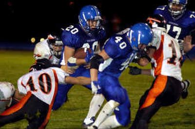 
Gabe Le (20) ran through the Flathead defense for 122 yards as Coeur d'Alene claimed a 34-7 season-opening victory over the Braves. 
 (Tom Davenport/ / The Spokesman-Review)