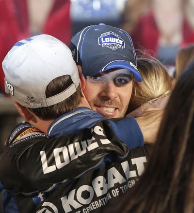 Jimmie Johnson hugs his crew in victory lane after winning Sunday. (Associated Press)