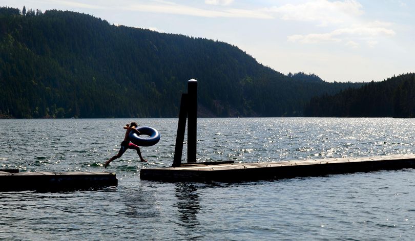 Brody Van Brethorst, 14, of Weiser, Idaho, jumps across the docks near the boat launch at Farragut State Park in Athol, Idaho, on Tuesday, June 23, 2015. (Kathy Plonka / The Spokesman-Review)