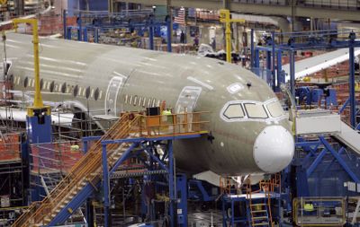 One of the first Boeing 787 jets is seen on the assembly line nearly surrounded by scaffolding during a media tour in Everett. (File Associated Press / The Spokesman-Review)