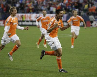 
Houston forward Brian Ching, second from right, celebrates. 
 (Associated Press / The Spokesman-Review)