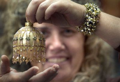 
Jody Young shows a holiday ornament and a bracelet made from the beads sold at her store, Beyond Beads Gallery, in Spokane Valley. Her store  has thousands of beads of all colors, sizes and shapes. 