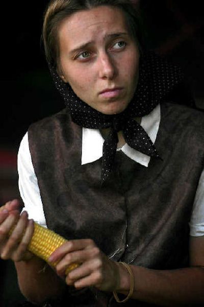 
Lois Gross husks corn that will be frozen and eaten over the next year by the Spokane Hutterite colony. 
 (The Spokesman-Review)