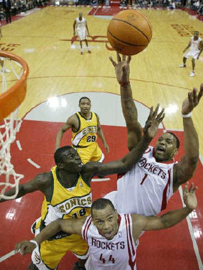 
Houston's Tracy McGrady  shoots over Seattle's Mouhamed Sene (18).
 (Associated Press / The Spokesman-Review)