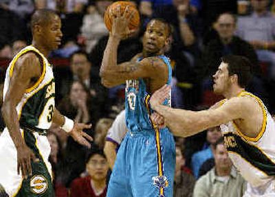 
Seattle's Ray Allen, left, and Nick Collison defend New Orleans' David West in the first half. 
 (Associated Press / The Spokesman-Review)
