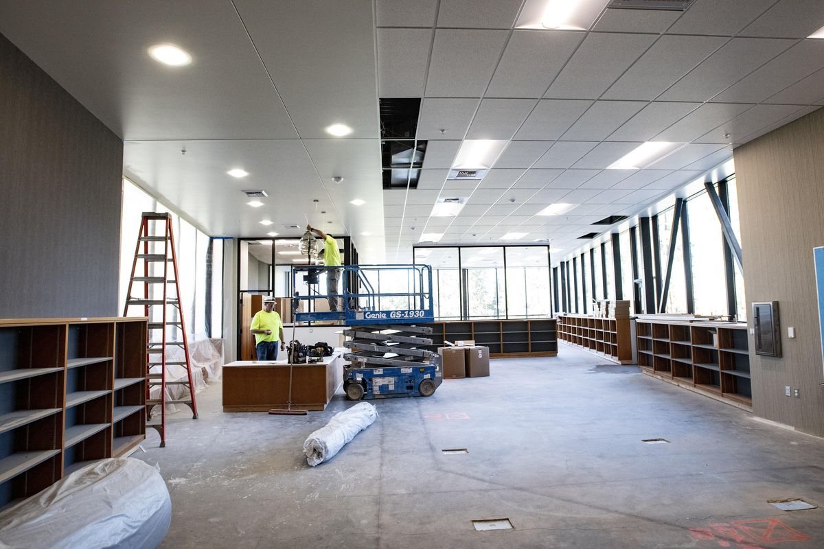 Eletricians install lighting in Franklin Elementary’s new library, Wed., Oct. 10, 2018. (Colin Mulvany / The Spokesman-Review)