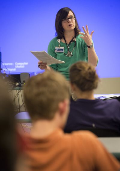At Providence Family Medicine Spokane, Dr. Liz Stuhmiller, a third-year resident, gives a presentation for other residents in the rural physician training track on how to identify the signs of a stroke in a patient. (Colin Mulvany)