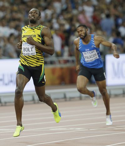 Jamaica's Usain Bolt coasts to a victory during his heat of the men’s 200m at the World Athletics Championships at Beijing. (Associated Press)