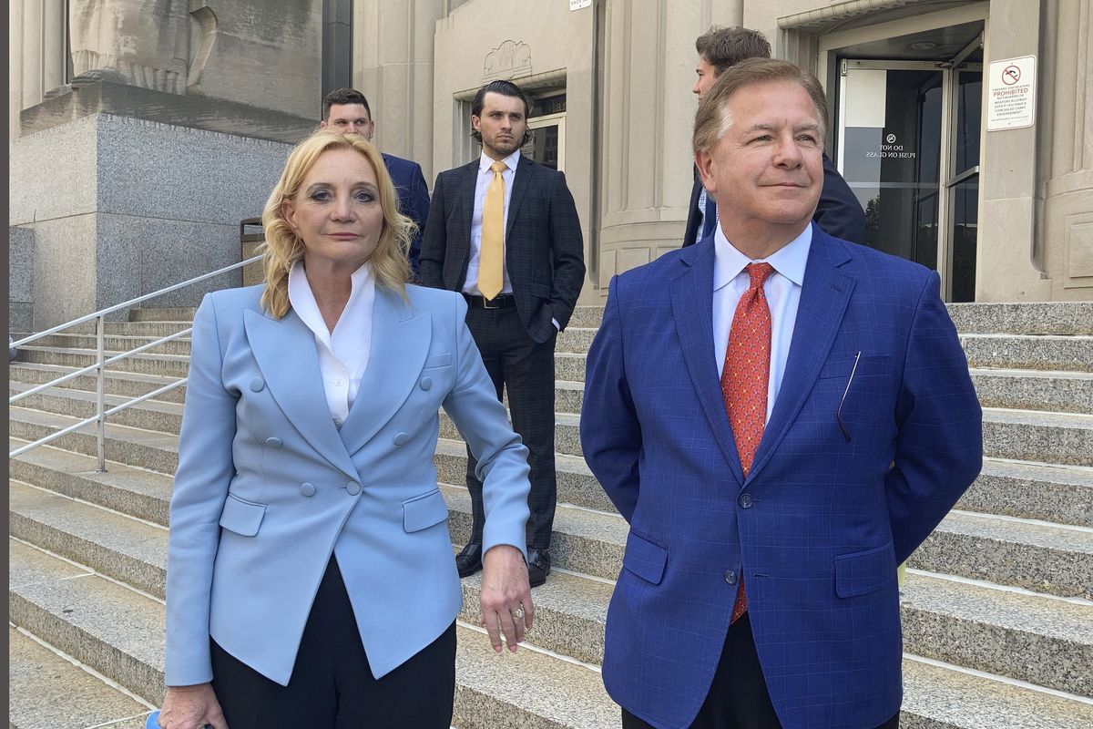 Patricia McCloskey, left, and her husband Mark McCloskey leave a court in St. Louis, Thursday, June 17, 2021. The St. Louis couple who gained notoriety for pointing guns at social justice demonstrators last year has pleaded guilty to misdemeanor charges. Patricia McCloskey pleaded guilty Thursday to misdemeanor harassment and was fined $2,000. Her husband, Mark McCloskey, pleaded guilty to misdemeanor fourth degree assault and was fined $750. The couple also agreed to forfeit both weapons they used when they confronted protesters in front of their home in June of last year. (Jim Salter)